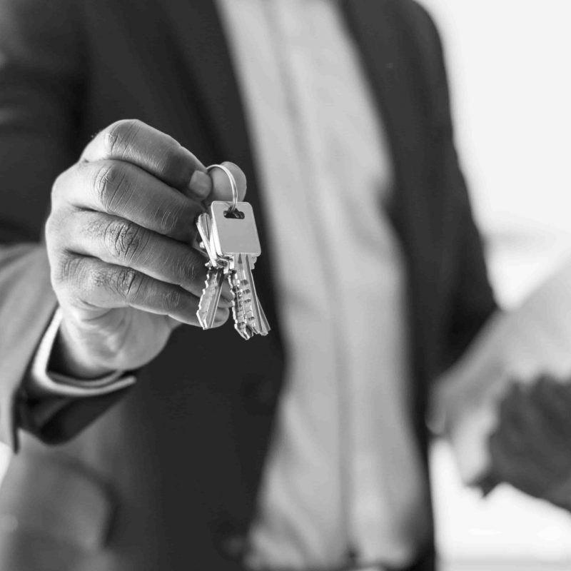 real-estate-agent-handing-the-house-key-min